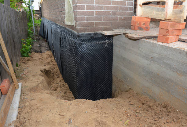 Happy homeowners after waterproofing job in Holton